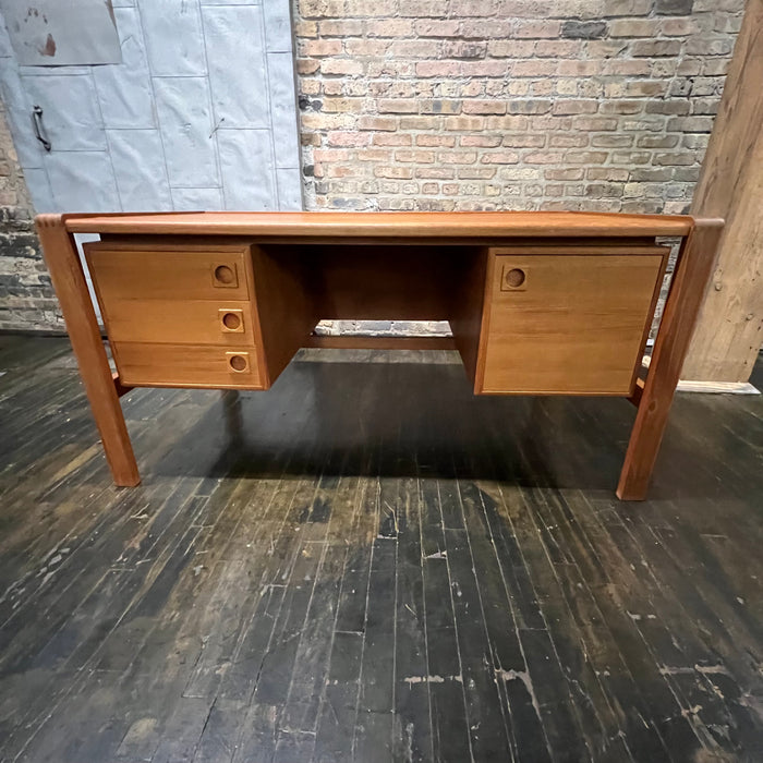 Mid-century executive floating top desk by H.P. Hansen manufactured in Demark circa 1970s. This beautiful desk was made of the highest quality teak.  The back of the desk is completely finished and has one inset opening that can be used for book storage or to display decorative items. STUDIO SONJA MILAN, Chicago, IL