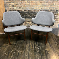 A pair of shell chairs with wood base and gray upholstery. Unmarked. Kofod-Larsen 