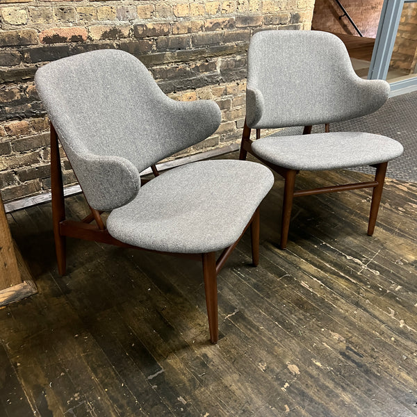 A pair of shell chairs with wood base and gray upholstery. Unmarked. Kofod-Larsen 