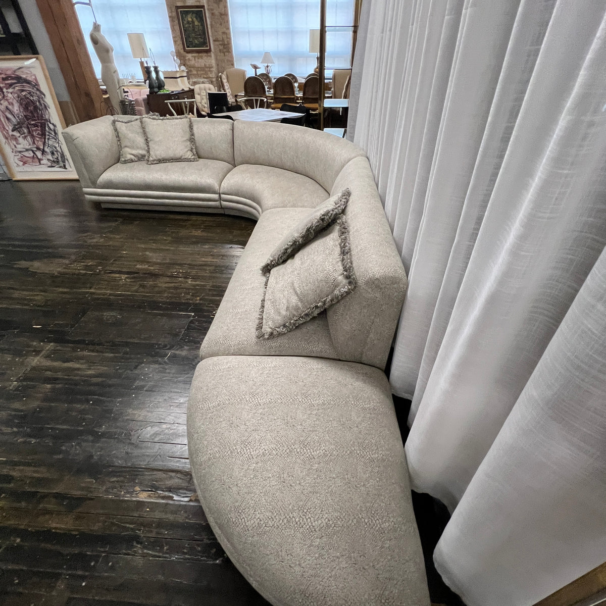 Mid-century curved sectional sofa attributed to Vladimir Kagan for Weiman Furniture. upholstered in a stunning neutral faux snakeskin fabric.